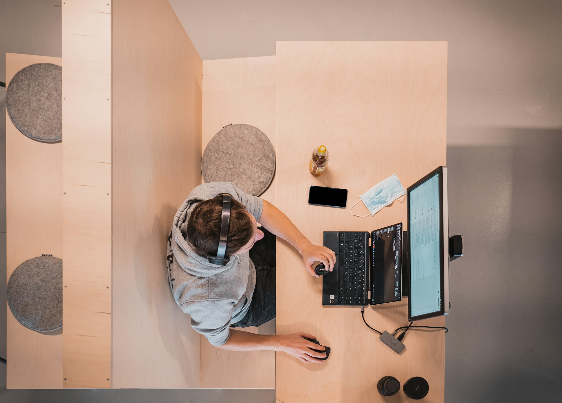 woman in blue shirt sitting on chair using laptop computer